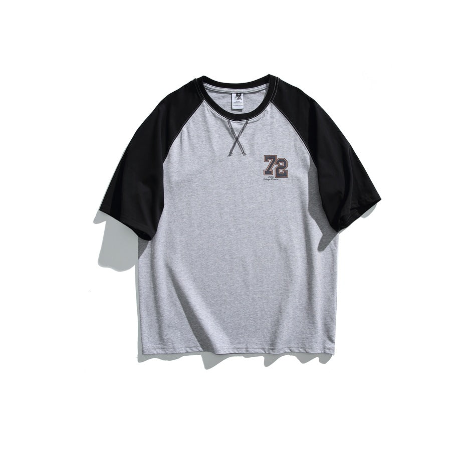 Front view of a gray raglan T-shirt with black sleeves, crossed neckline stitching and a 72 chest graphic.