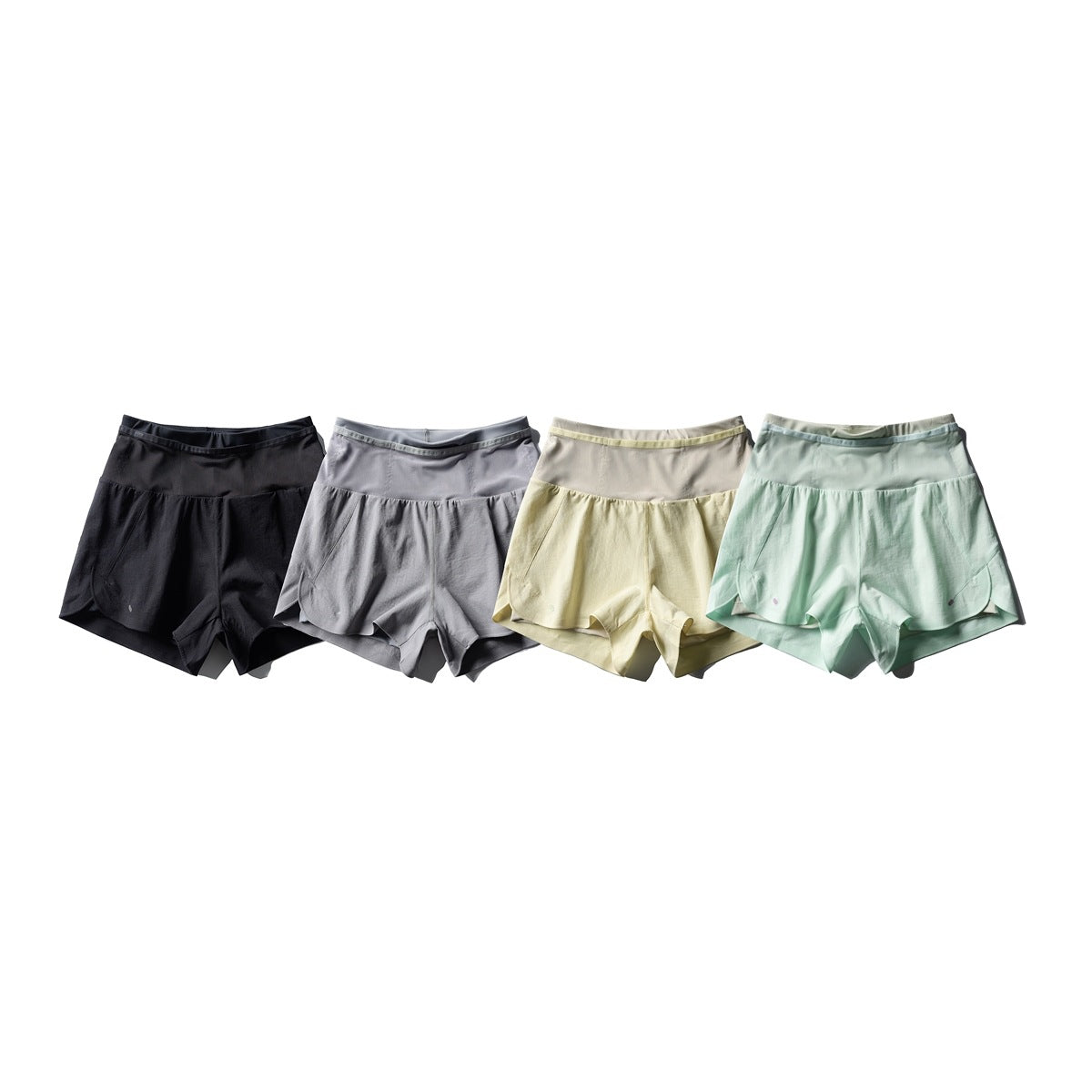 Four pairs of layered running shorts shown together in black, gray, pale yellow, and mint.