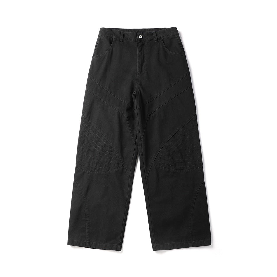 Black wide-leg pants flat lay, front view, with diagonal thigh seams and stitched knee panels