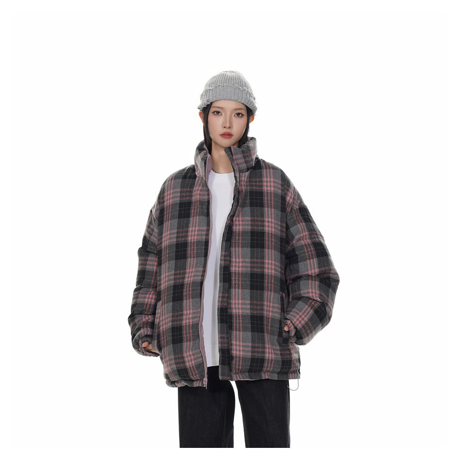 Model wearing a charcoal and pink plaid puffer jacket with a high collar, styled with a gray beanie and dark pants.