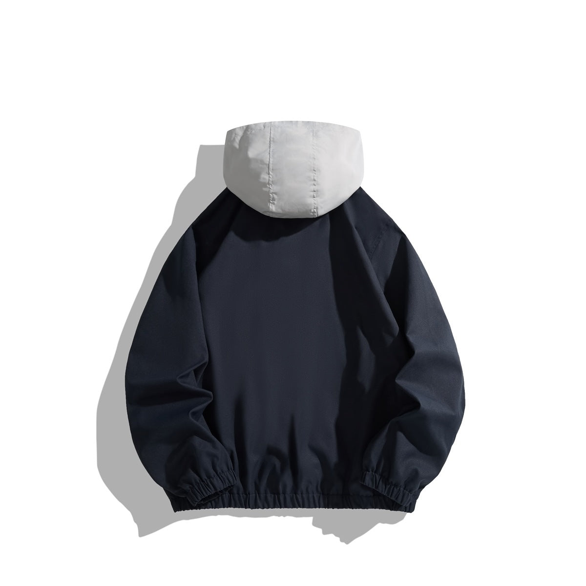 Back view of a navy hooded jacket with a light gray hood and gathered cuffs and hem.