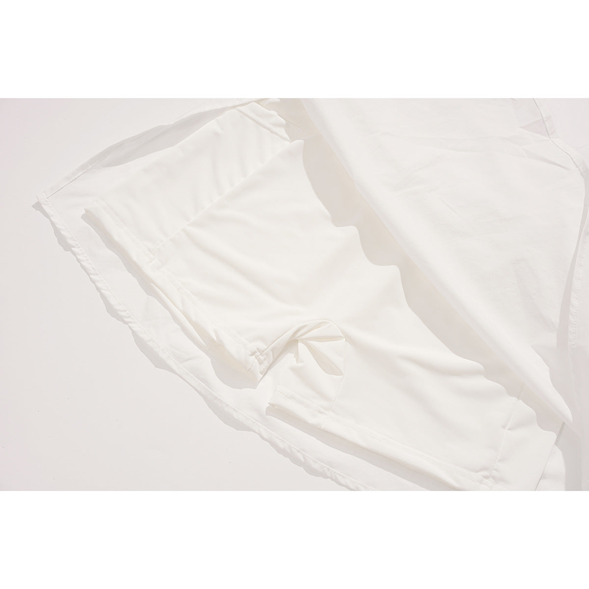 Inside view of a white skirt showing its sewn-in shorts lining and seams.
