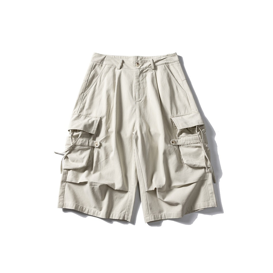 Off-white knee-length cargo shorts, front view, with large flap side pockets, strap tabs and button waist
