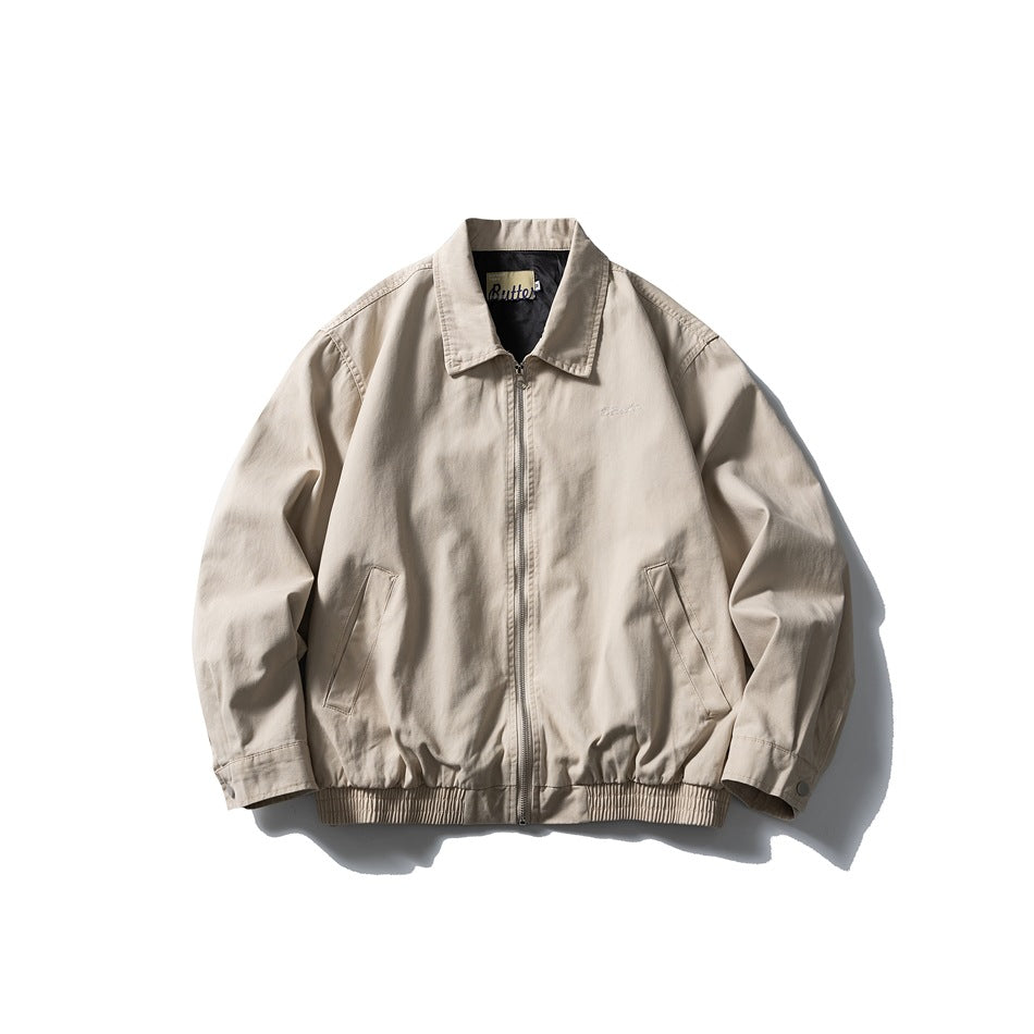 Beige collared zip-front jacket flat lay with slanted pockets, snap cuffs and ribbed hem