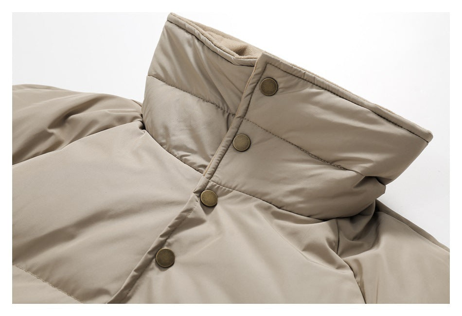 Close-up of a beige padded jacket collar with a snap-button front.