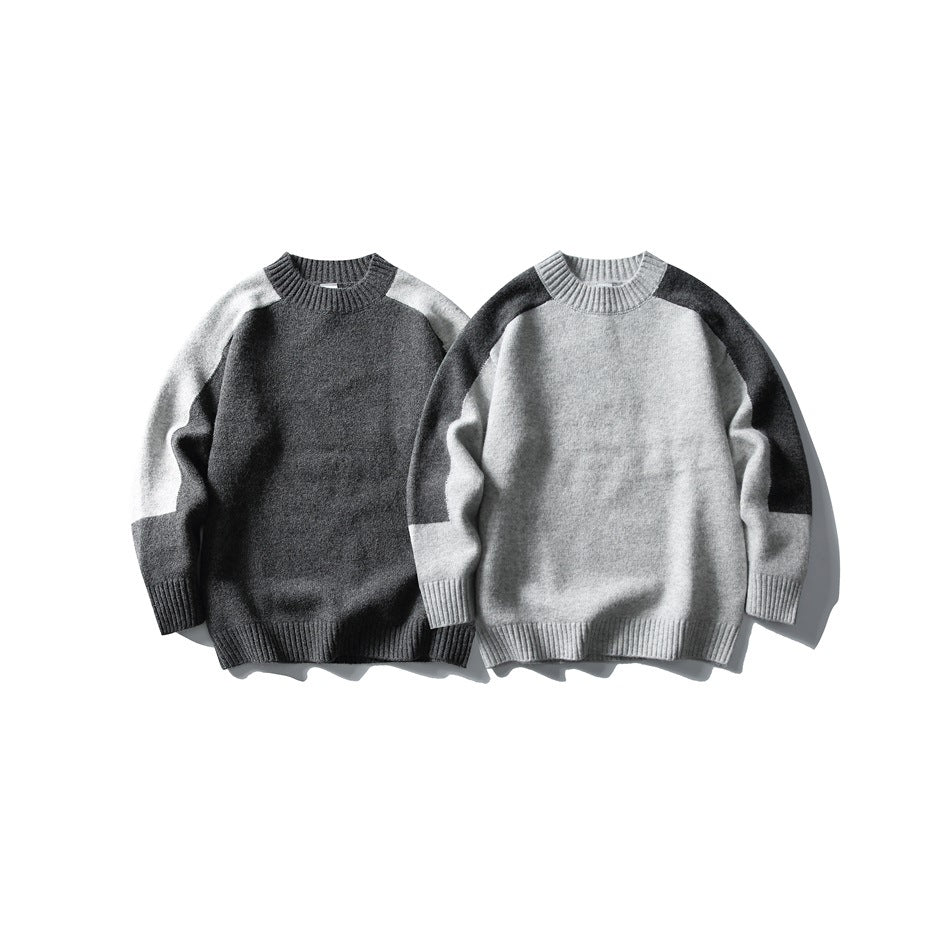 Two colorways of a crew-neck sweater shown from the front: charcoal with light gray panels and light gray with charcoal