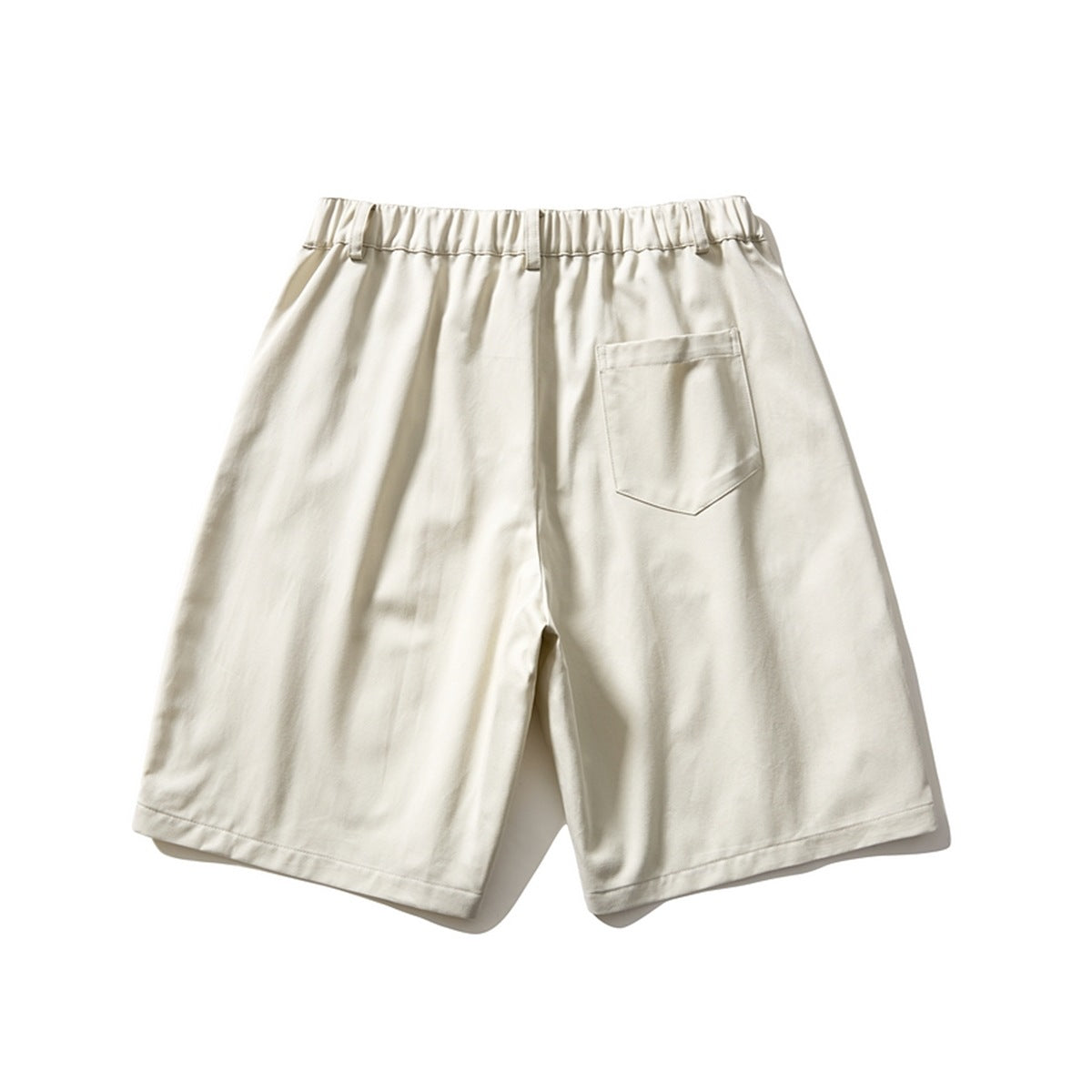 Back view of off-white shorts with elastic waistband and a single patch pocket