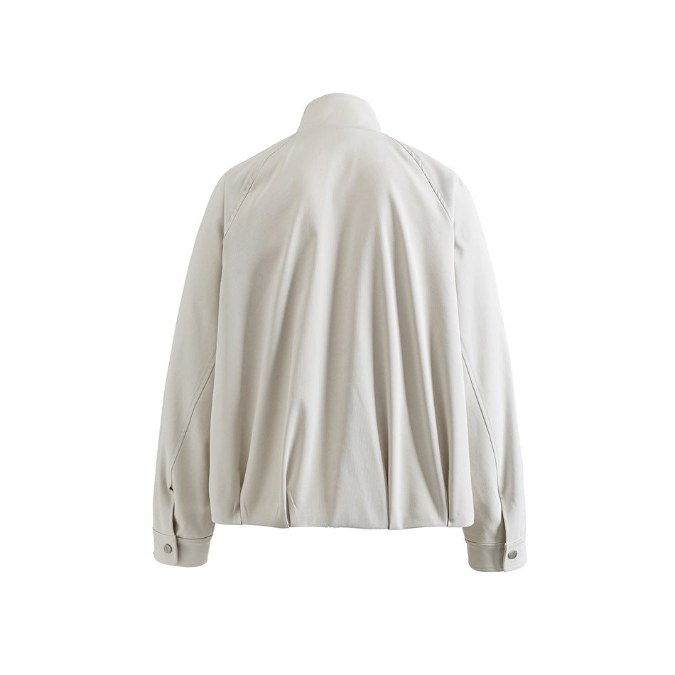 Back view of an off-white jacket with a gathered center back, long sleeves, and buttoned cuffs.