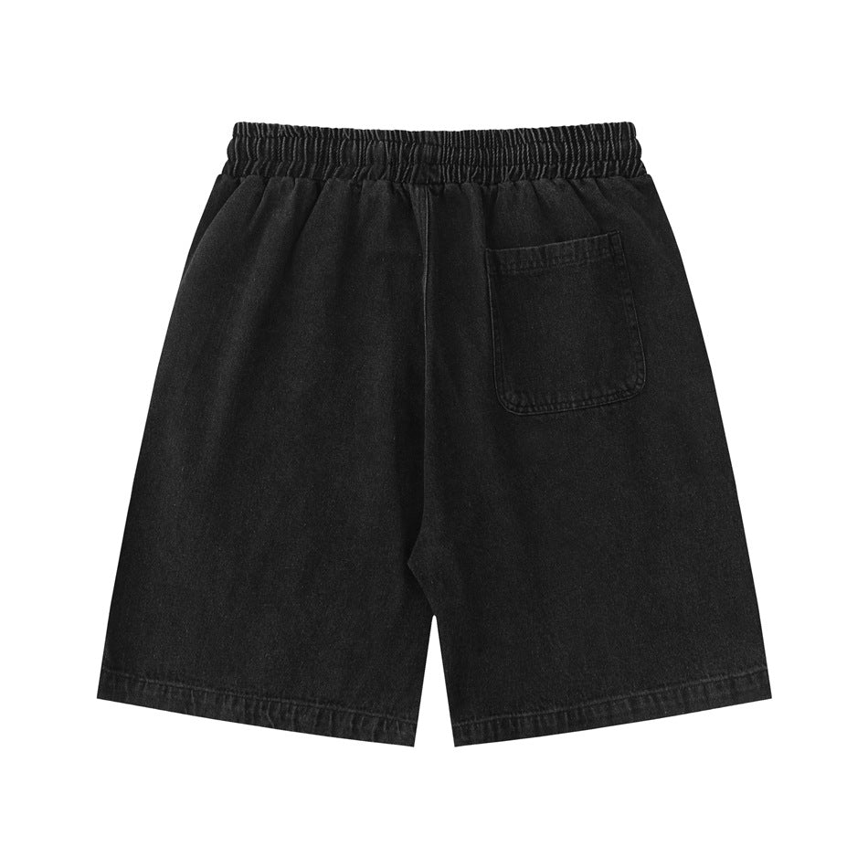 Back view of black denim shorts with an elastic waistband and a single patch pocket.