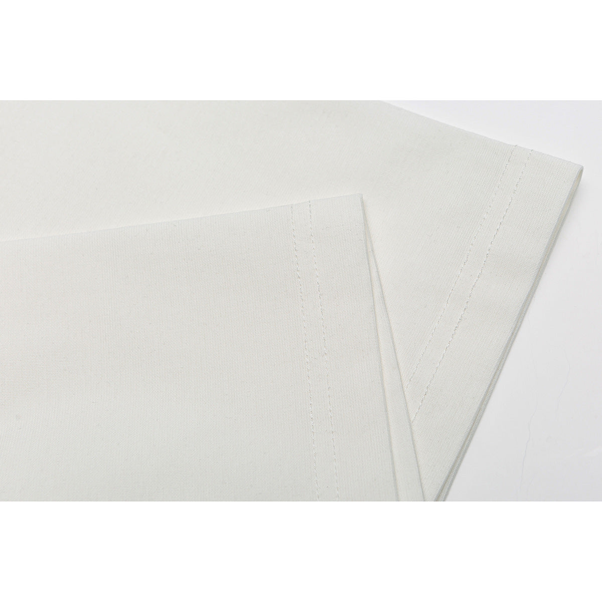Close-up of the sleeve and double-stitched hem on an off-white T-shirt.