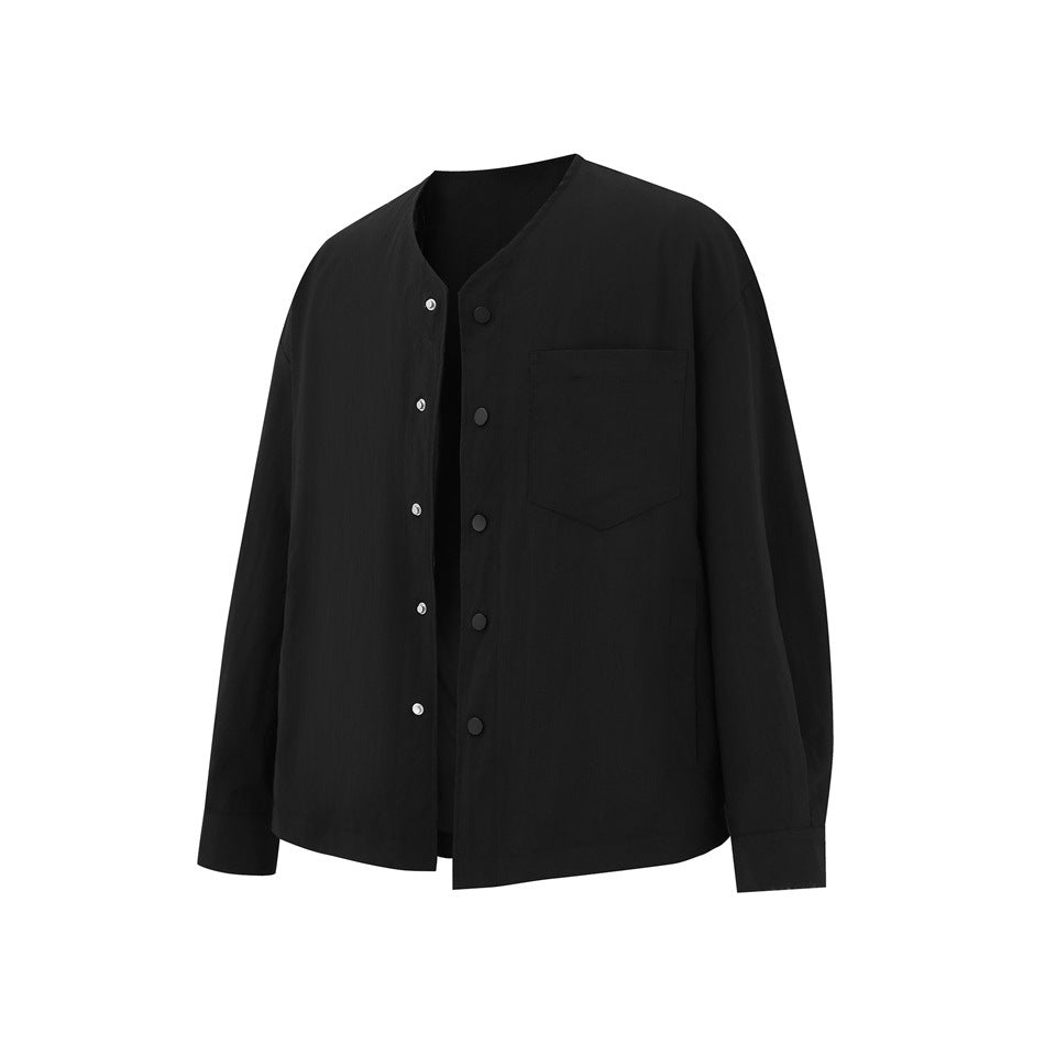 Black collarless button-front jacket with chest pocket, angled front view with placket partly open