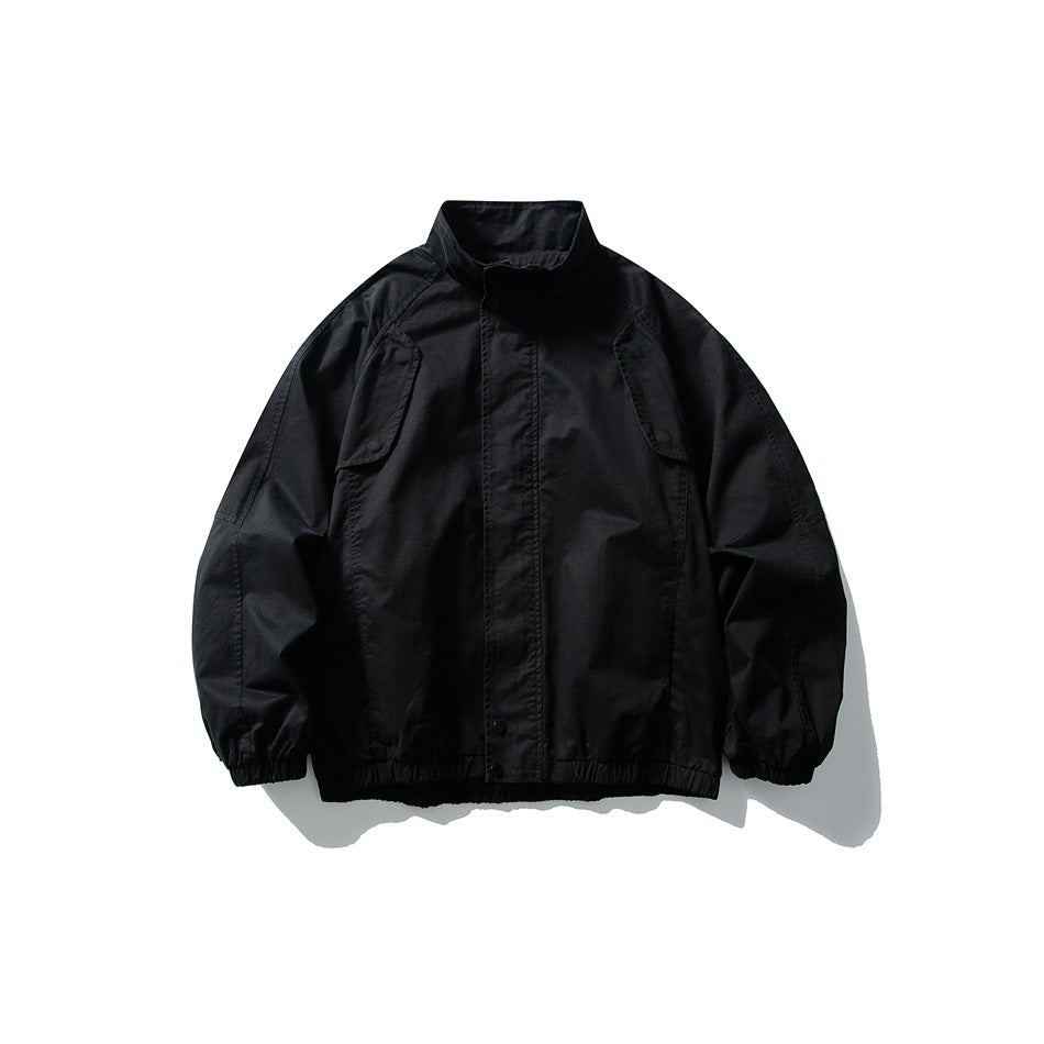 Black stand-collar jacket flat lay with front placket, shoulder flap details, elastic cuffs and hem band