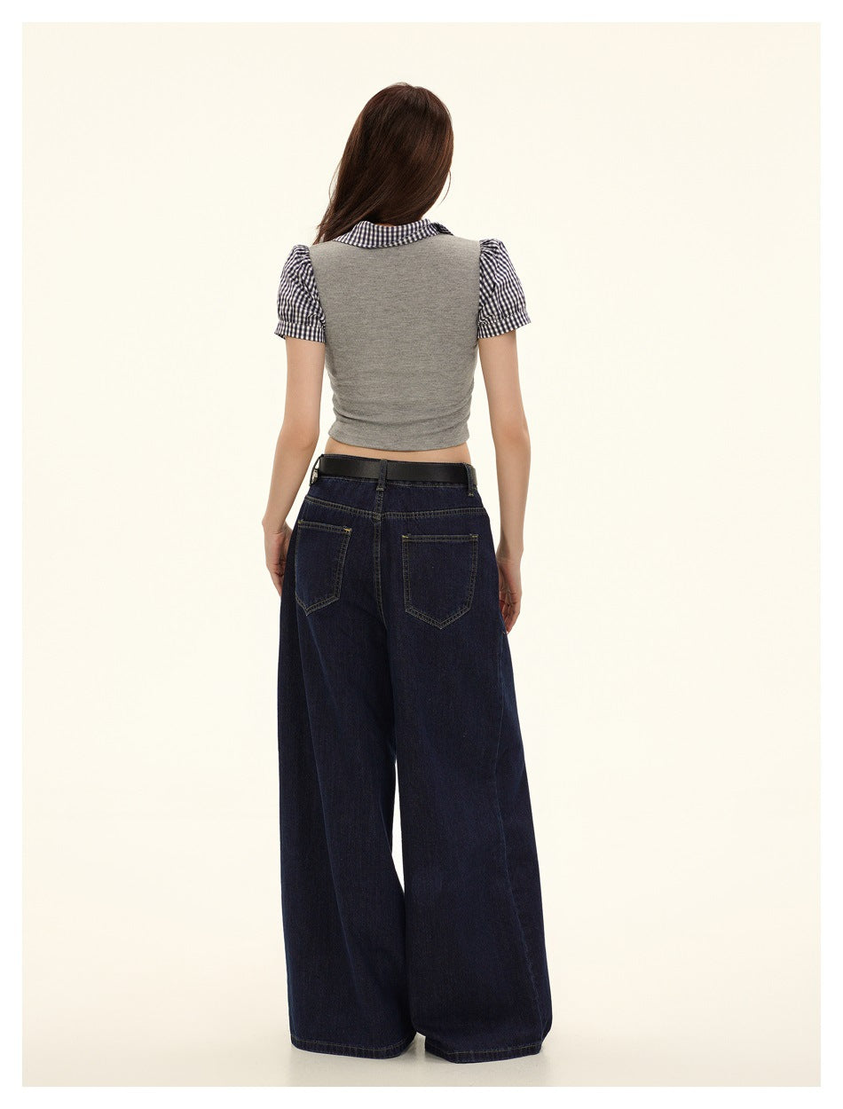 Back view of a model wearing a gray cropped top with gingham collar and short puff sleeves.