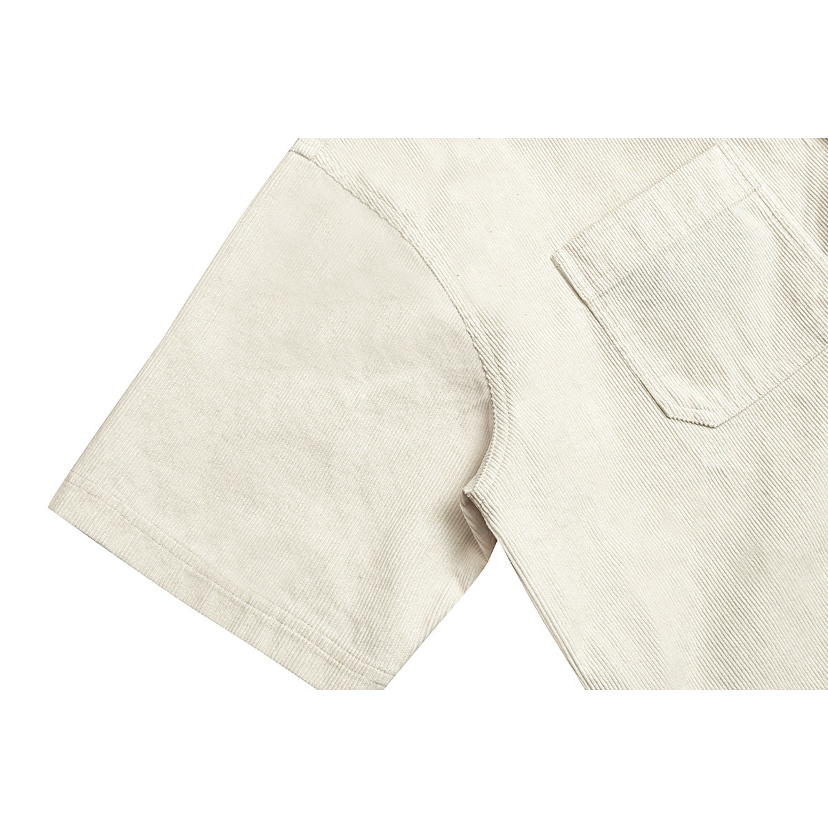 Close-up of a cream ribbed short-sleeve shirt showing the sleeve seam and chest pocket.