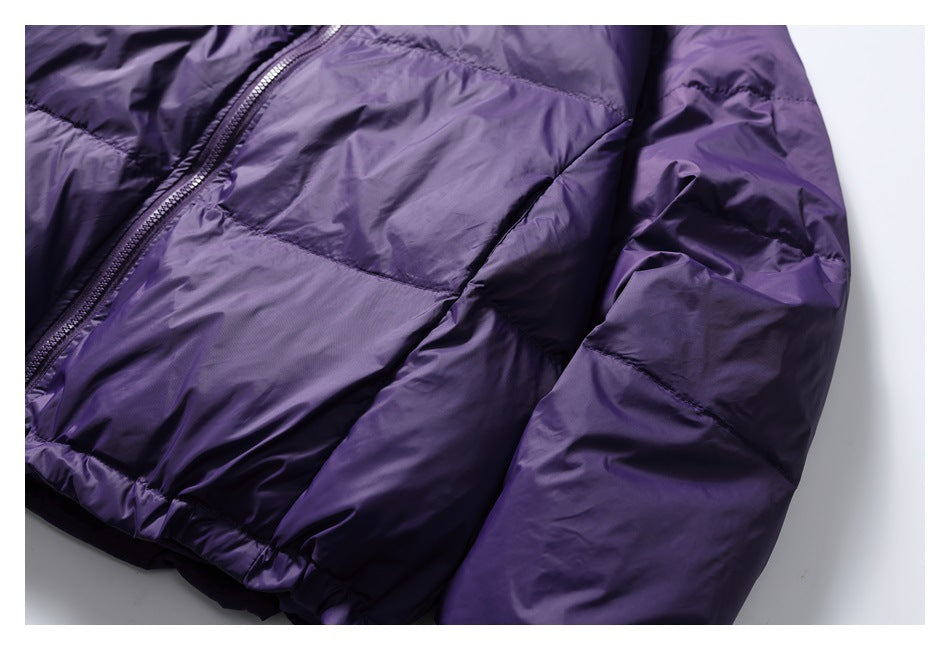 Close-up of a purple jacket's quilted body, front zipper and sleeve.