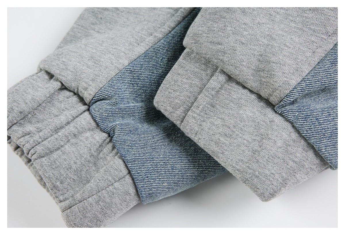 Close-up of folded gray knit and blue denim sections with visible seams and hems.