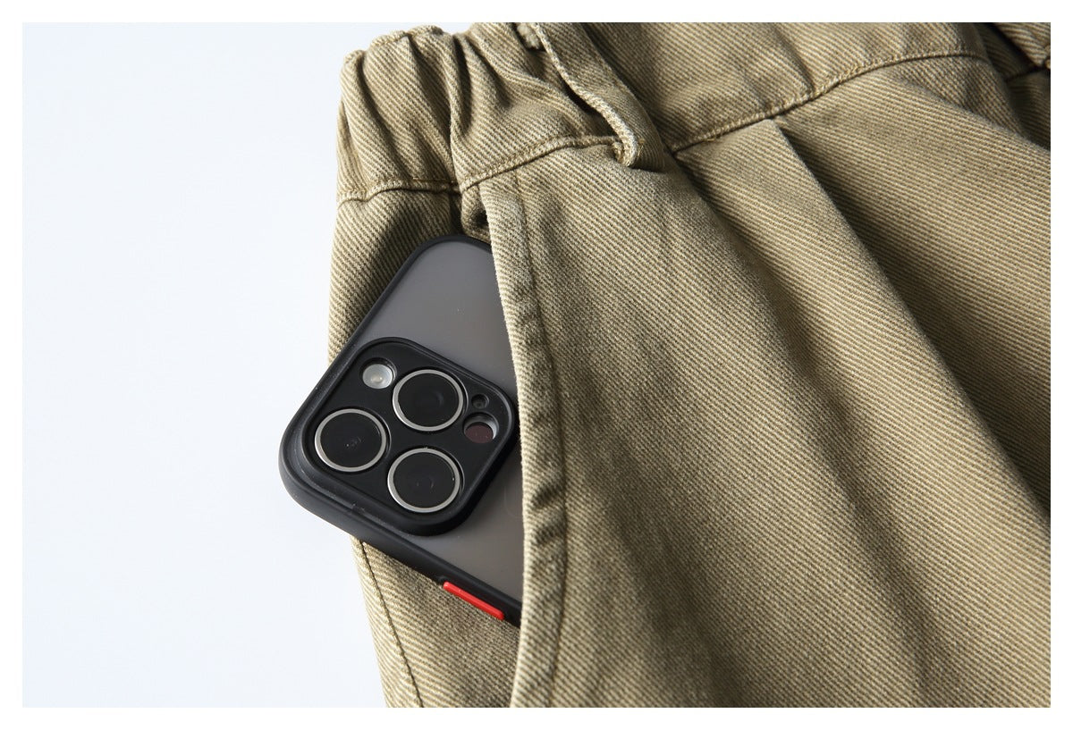 A phone tucked into a pocket on a tan twill garment, showing the pocket opening and stitching.