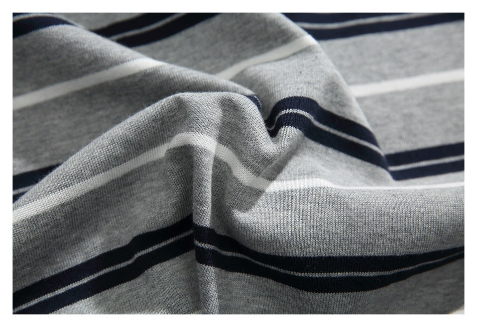 Close-up showing the knit texture and navy-and-white horizontal stripes of gray fabric.