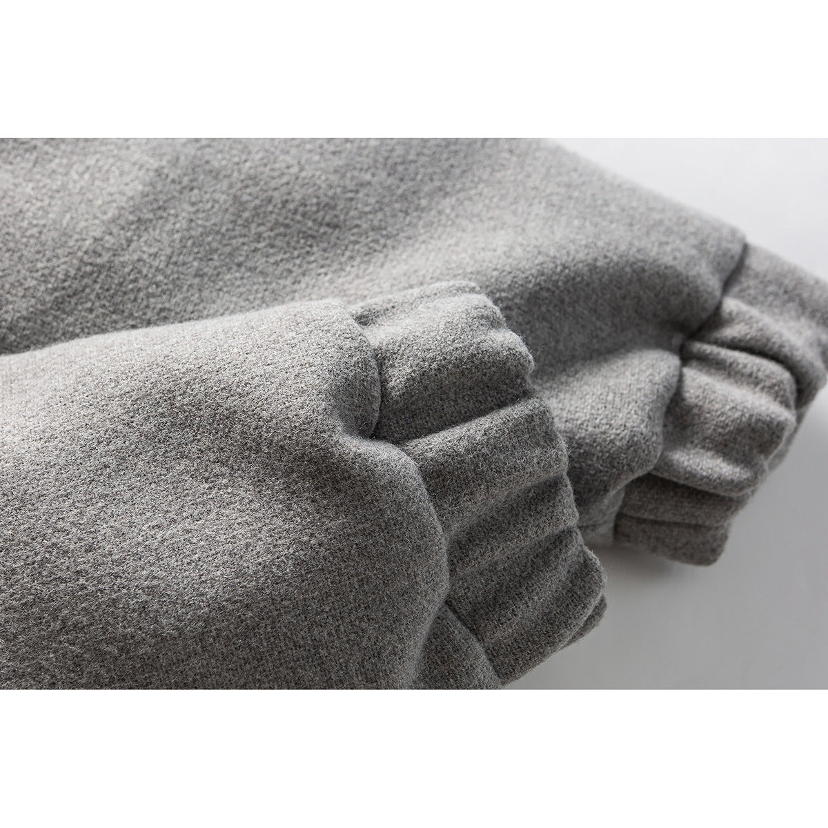 Close-up of the gray jacket sleeve and gathered cuff.