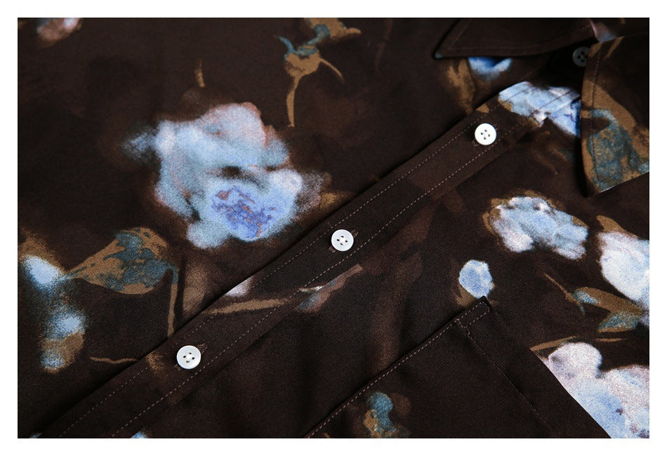 Close-up of the floral shirt's front button placket with white buttons and stitching.
