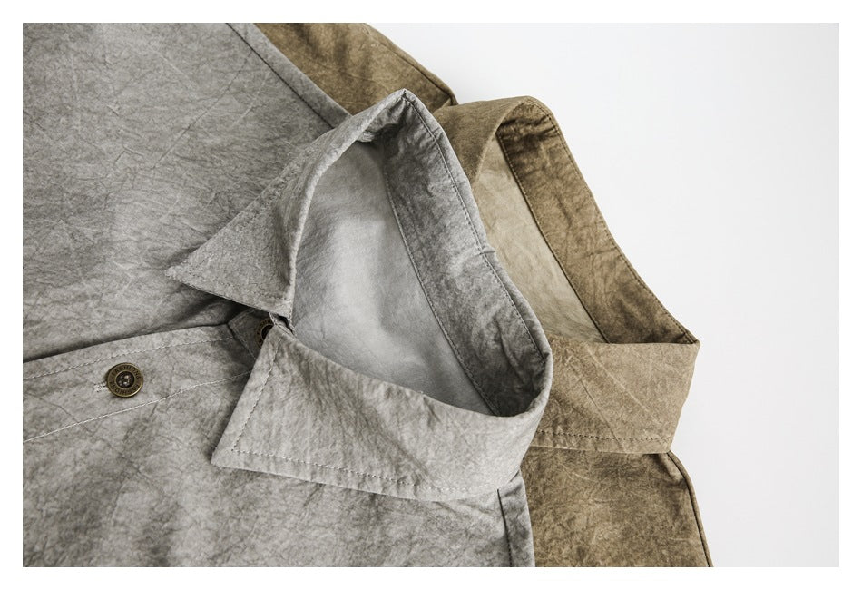 Close-up of gray and khaki-brown shirt collars and front plackets, showing the washed, crinkled surface and buttons.
