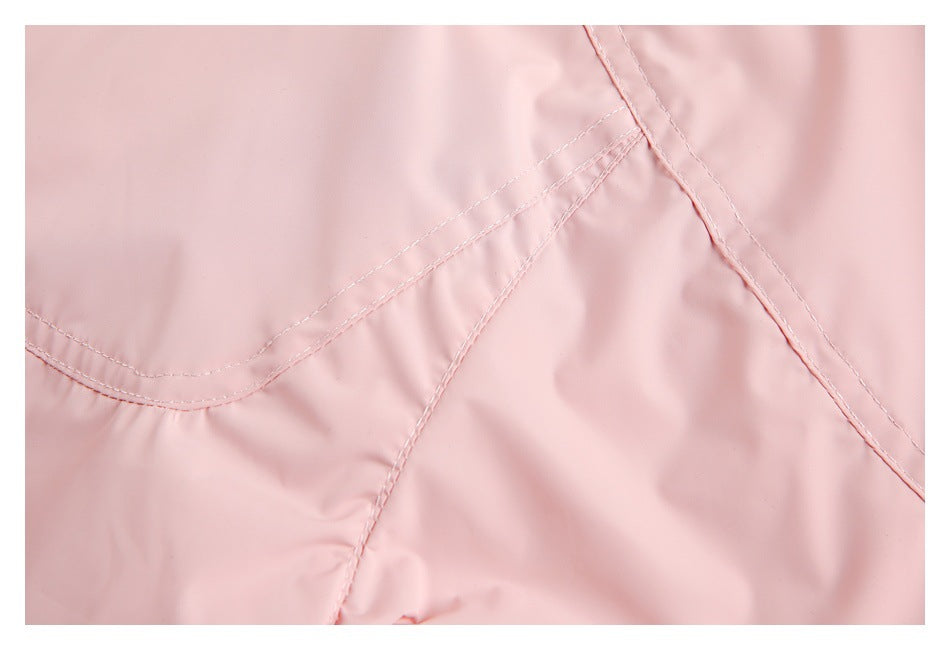 Close-up of pale pink garment fabric with curved and diagonal stitched seams.