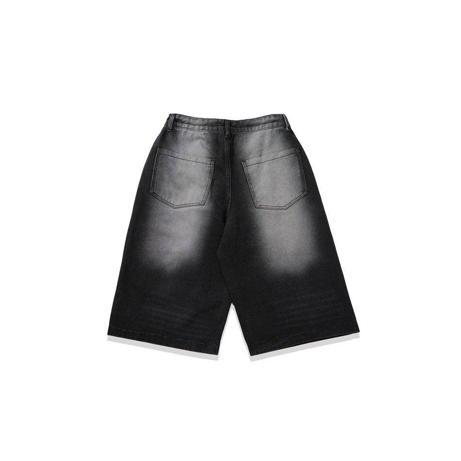 Back view of charcoal-black denim shorts with two square patch pockets and faded wash.