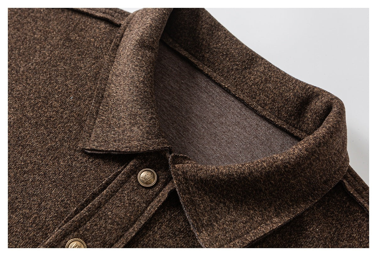 Close-up of a dark brown heathered jacket collar, lapel, and ornate brass-tone buttons.