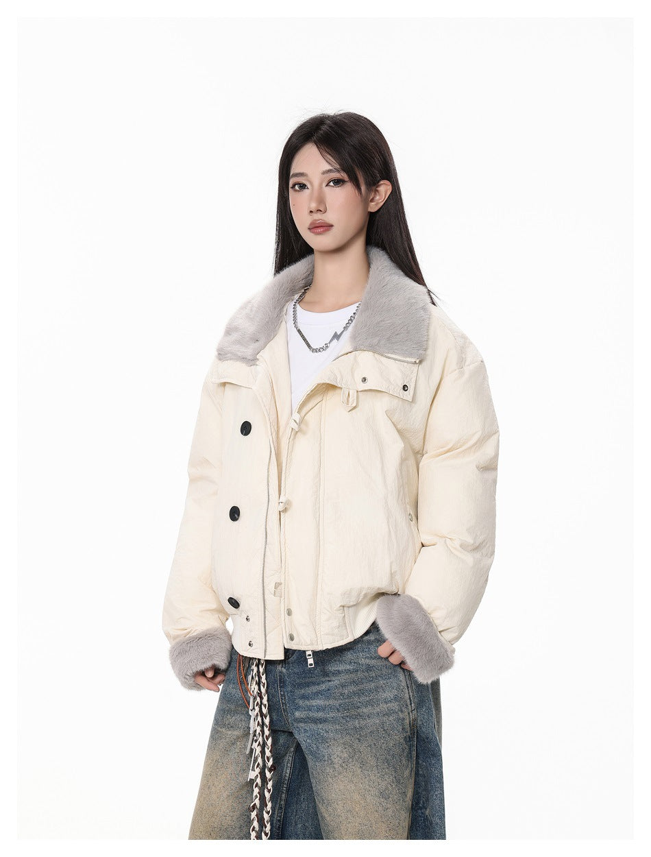 Three-quarter view of a model wearing an ivory jacket with a gray faux-fur collar and cuffs.