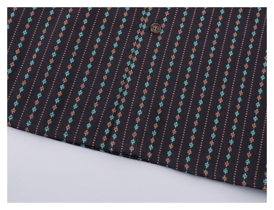 Close-up of the button placket and repeating turquoise and rust pattern on the dark shirt.