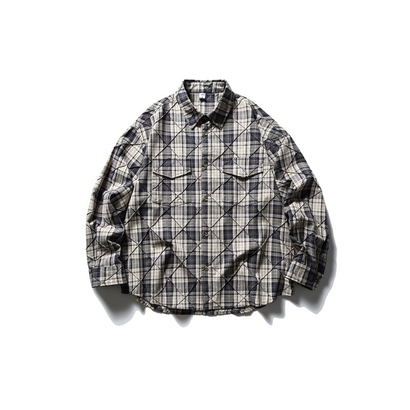 Navy and cream plaid long-sleeve shirt with diamond stitched lines and flap chest pockets, laid flat, front view