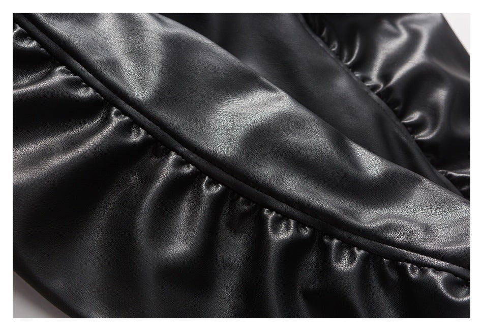 Close-up of a black jacket's gathered seam and narrow piping.