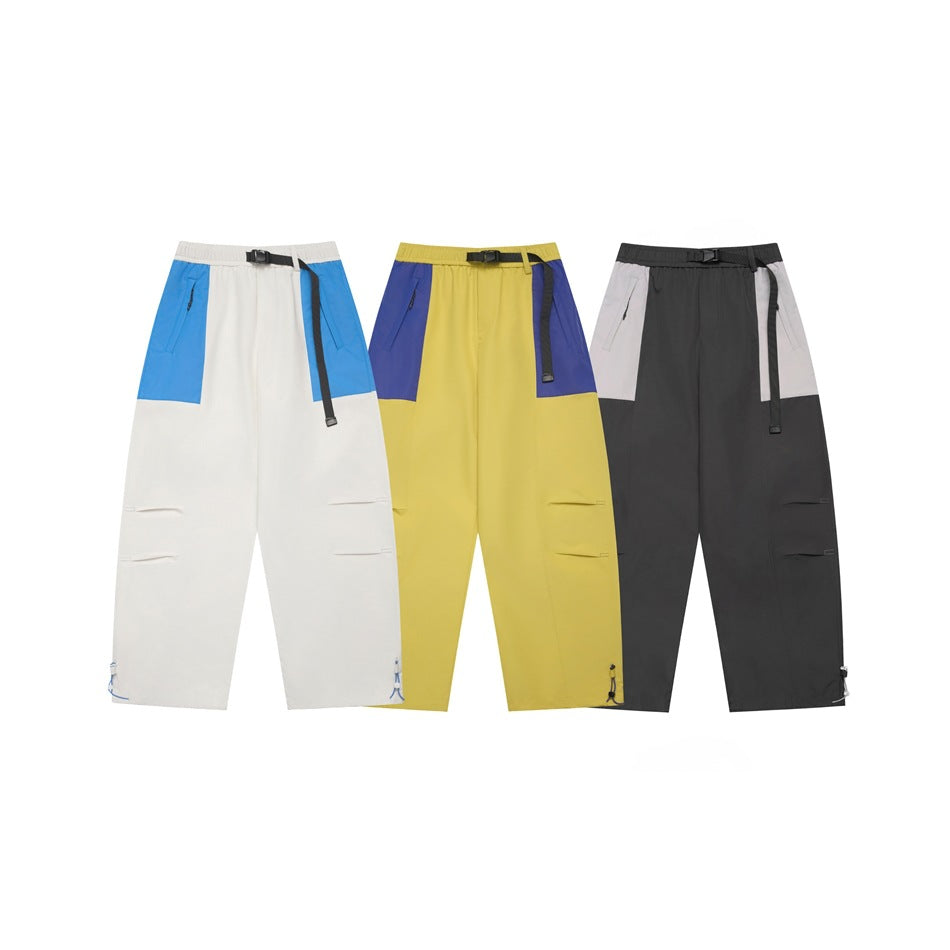 Three front views of loose pants in white and blue, yellow and purple, and charcoal and light gray colorways.