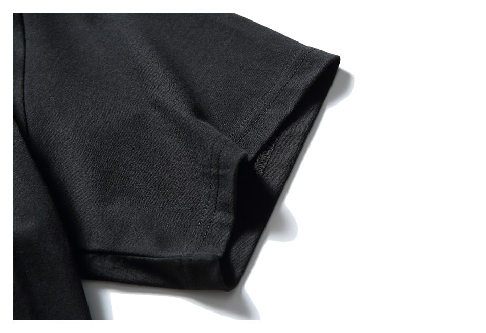 Close-up of the black T-shirt sleeve opening and stitched seam.