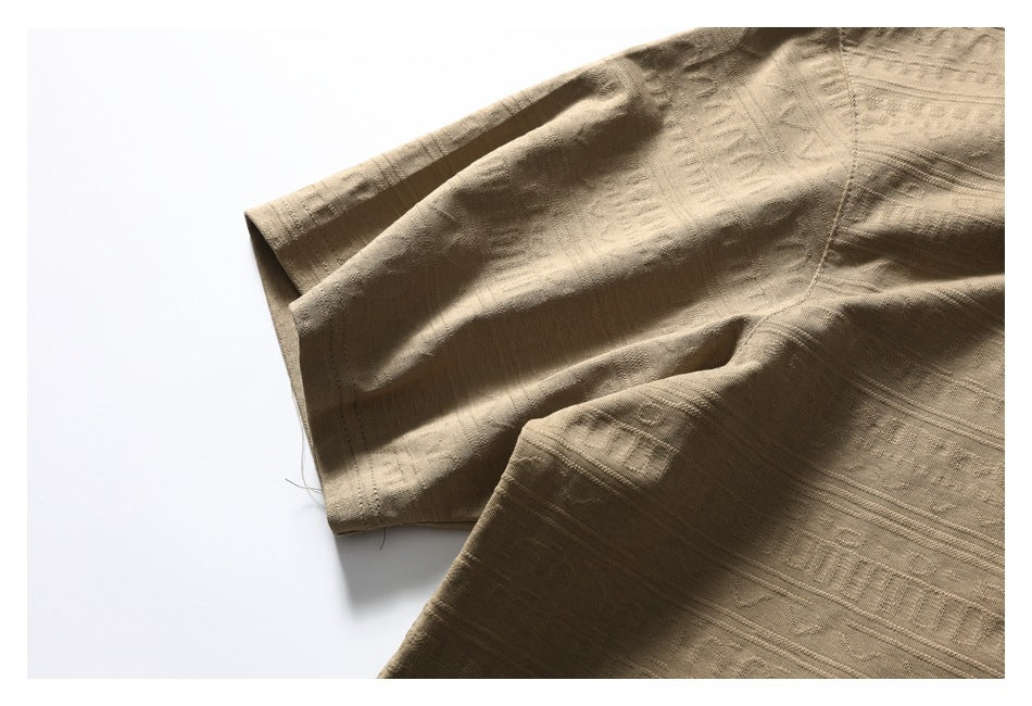 Close-up of the tan shirt's short sleeve, stitching, and textured fabric.