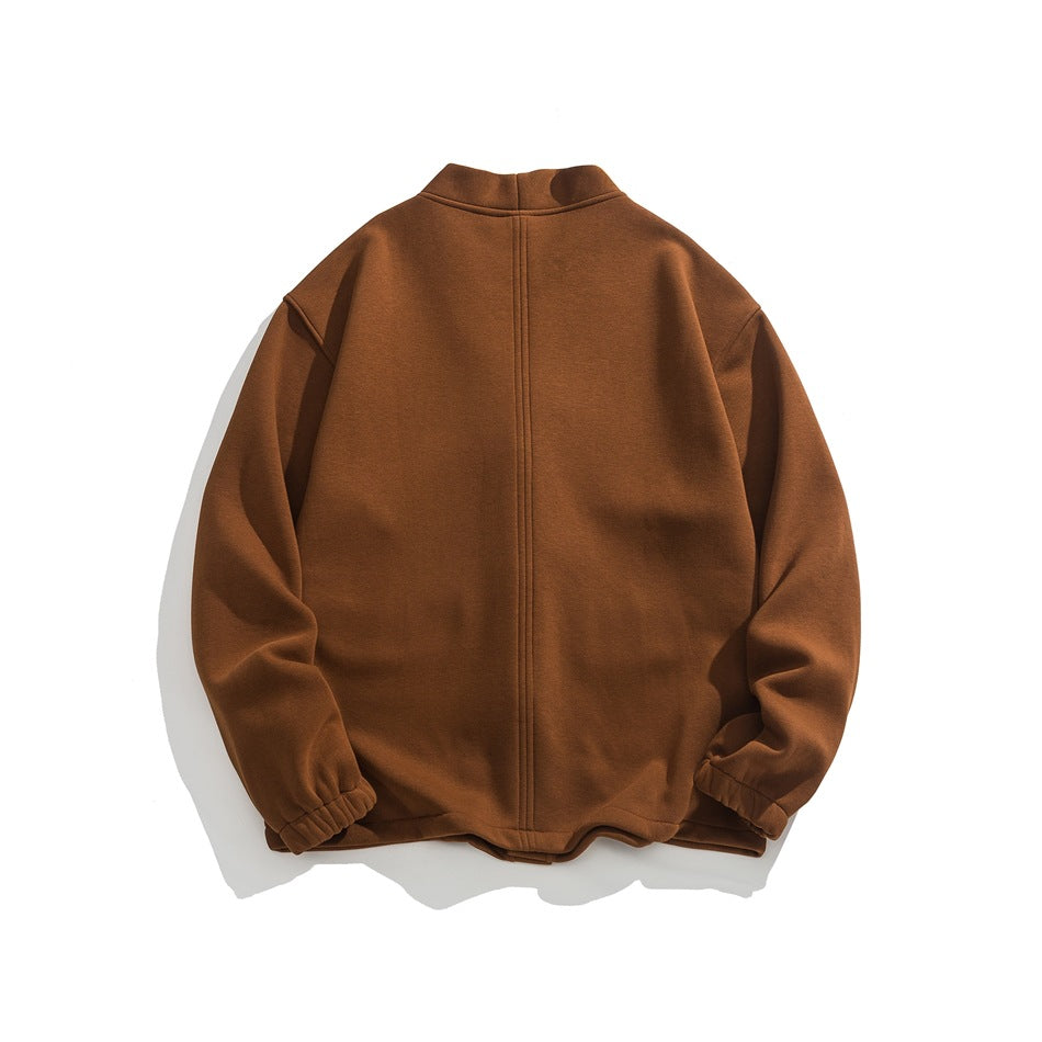 Back view of a rust-brown jacket with a stand collar, center seam, and elastic cuffs.