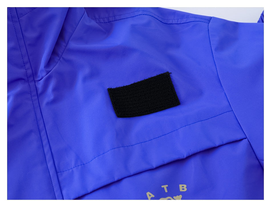 Close-up of a black rectangular patch on the blue jacket's chest pocket flap.
