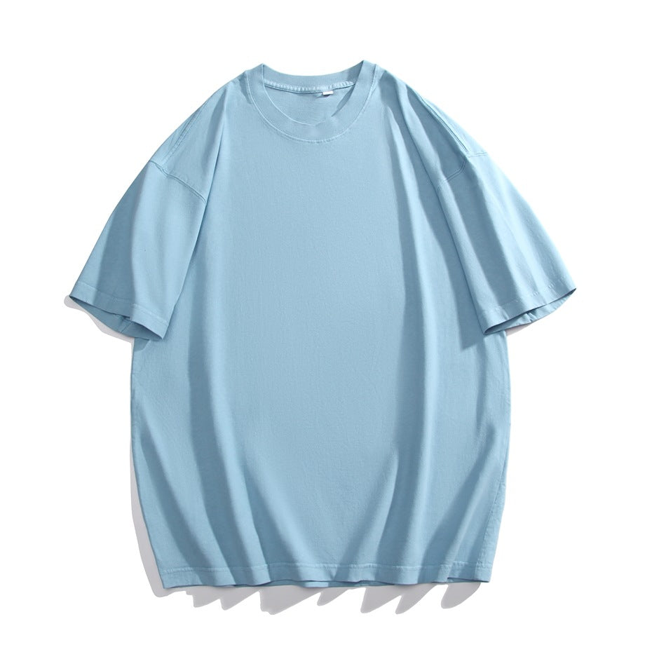 Light blue short-sleeve crew neck T-shirt with dropped shoulders, flat lay on a white background