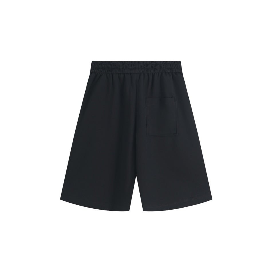 Back view of black shorts with an elastic waistband and a rectangular patch pocket.
