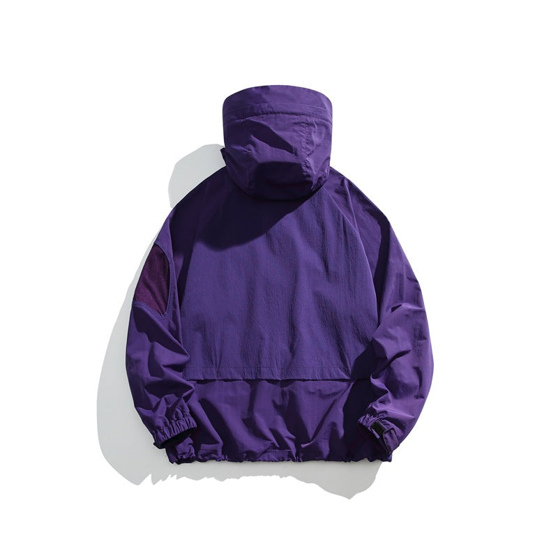 Back view of a purple hooded jacket with a large rear panel and elastic cuffs and hem.