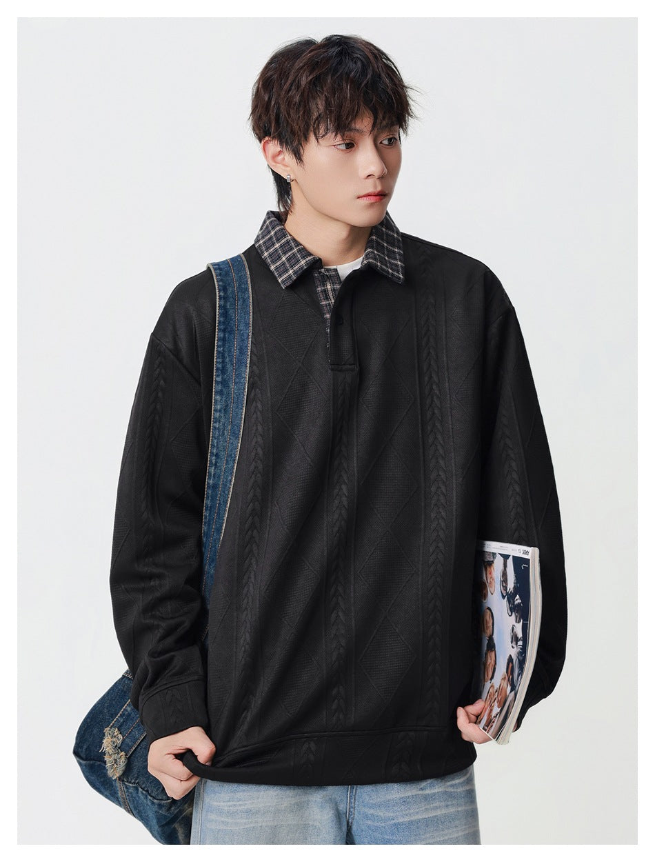Model wearing a black textured pullover with a plaid collar and button placket, carrying a denim bag and magazine.