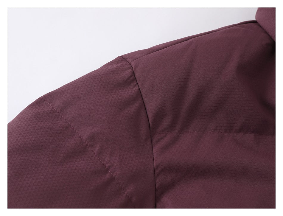 Close-up of the burgundy jacket shoulder seam and subtle geometric fabric texture.
