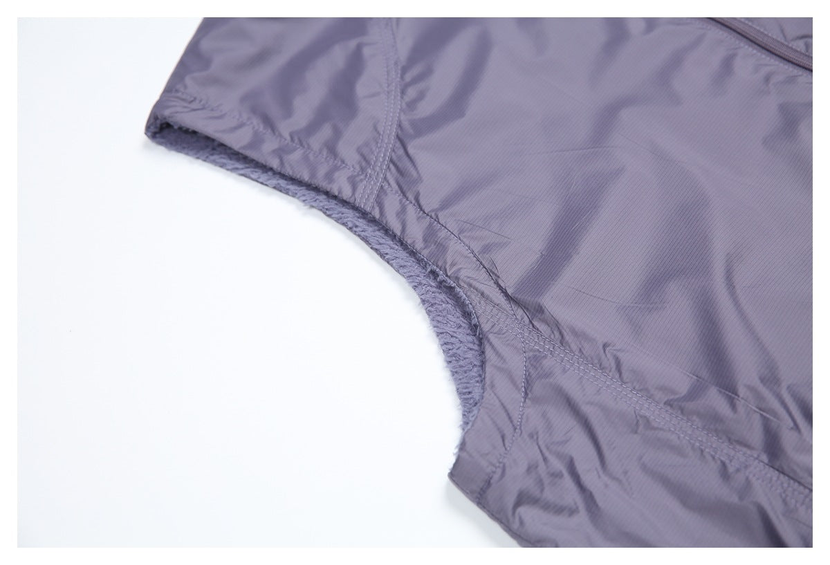 Close-up of the vest's sleeveless armhole, showing the fuzzy lining and stitched shell edge.