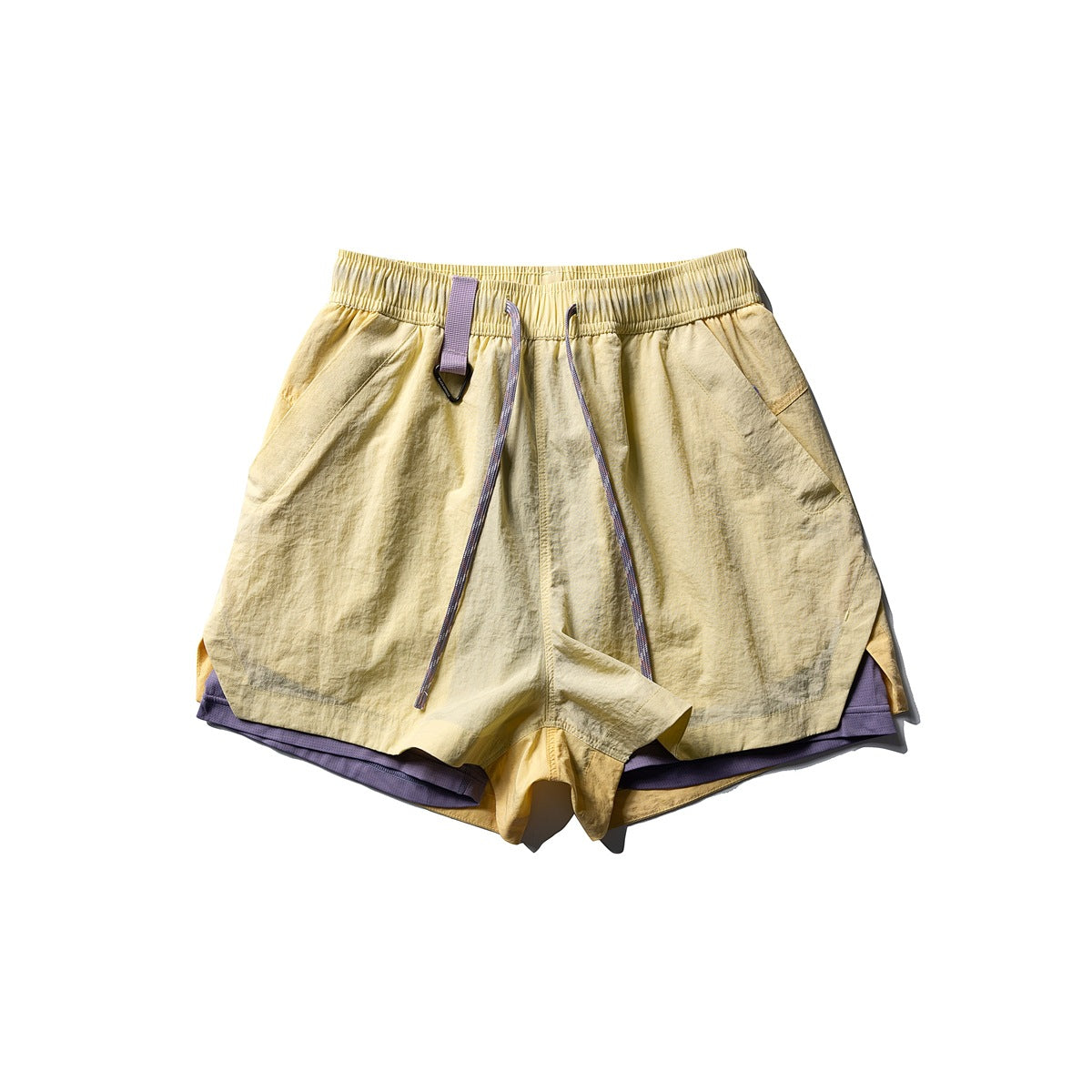 Flat-lay front of pale yellow shorts with elastic waist, purple drawstring, ring loop and purple inner layer