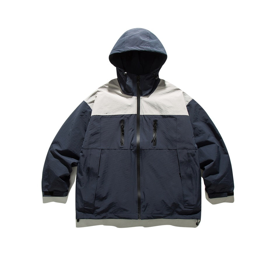 Navy hooded full-zip jacket with light gray shoulder yoke, chest zip pockets and hem drawcord, flat lay