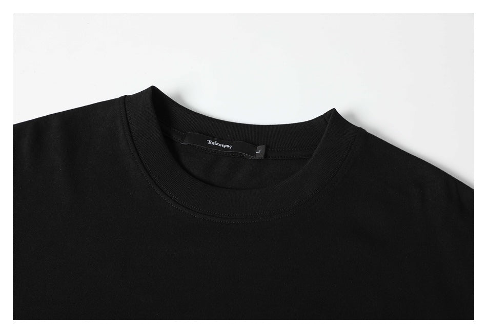 Close-up of the black T-shirt's ribbed crew neckline and inner neck label.