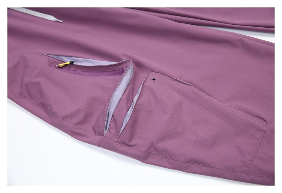 Mauve pants detail showing a zip pocket and a flap pocket with pale gray lining and a metal eyelet.