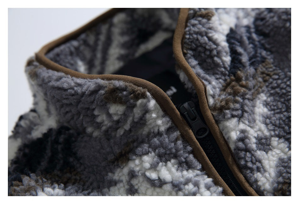 Close-up of the fleece jacket's collar and black zipper, finished with brown binding.