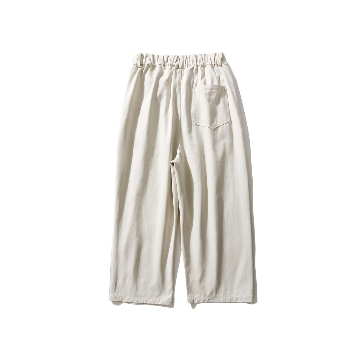 Back view of ivory wide-leg pants with an elastic waistband and one patch pocket.