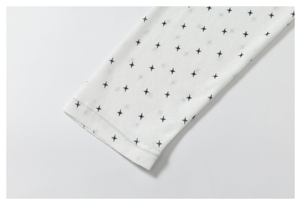 Close-up of a white sleeve cuff with a repeating small black star print.